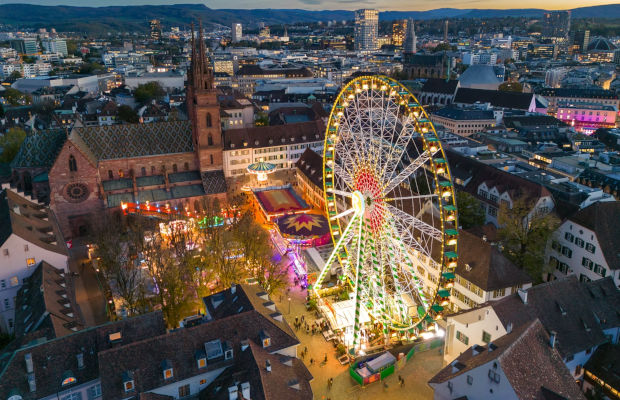Das Riesenrad auf dem Basler Münsterplatz bei Abenddämmerung.